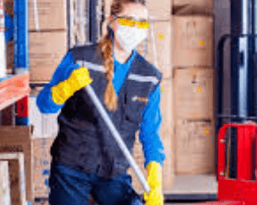 Cleaner holding a mop in her hands